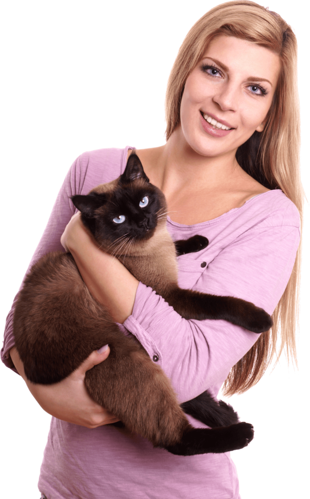 A woman holding a siamese cat in her arms.